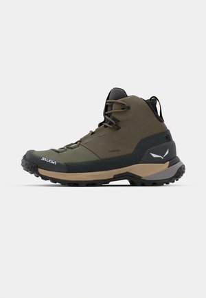 High-top hiking boots in olive green and black. Features rubber sole with traction, lace-up design, and reinforced toe cap.