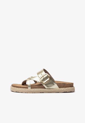 Gold metallic cross-strap sandals with a beige cork sole and woven edge. Features a decorative gold buckle and textured finish.
