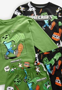 Ensemble de pyjama sur le thème de Minecraft, vert et noir, comprenant un haut à manches longues et un short, avec des impressions graphiques de personnages et de blocs de TNT.