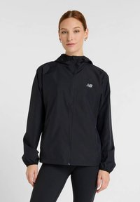 Black lightweight zip-up jacket with a hood, featuring elastic cuffs and a reflective logo on the left chest. Smooth texture.