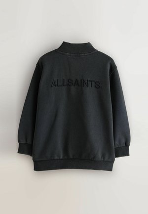 Černá mikina s vysokým límcem a žebrovanými manžetami. Na zadní straně je vyšitý nápis "ALLSAINTS". Hladká textura, volný střih.