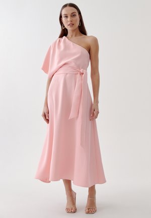 Roze, een-schouder jurk van zachte stof, beschikt over een getailleerde top, vloeiende rok en een knoopdetail bij de taille. Minimalistisch ontwerp.