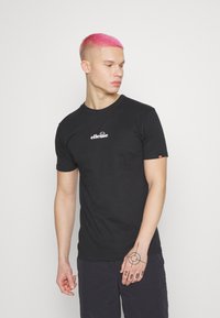 Black short-sleeve t-shirt in cotton with a white "ellesse" logo on the chest. Features a crew neckline and a small logo detail on the sleeve.