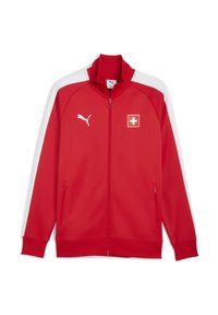 Rød lynlås track jakke med hvide detaljer, høj krave og logo detaljer. Har sidelommer og ribbede manchetter. Fremstillet af letvægtsmateriale.