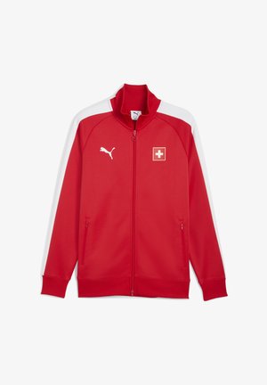 Hanorac de sport roșu cu fermoar, cu accente albe, guler înalt și detalii cu logo. Are buzunare laterale și manșete cu nervuri. Fabricat dintr-un material ușor.