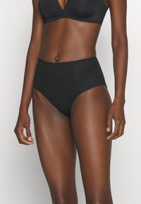Black high-waisted panties with a textured pattern, smooth edges, and a full coverage design. Soft fabric with elasticity for comfort.