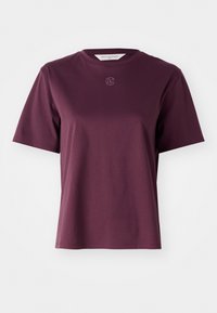Burgundy cotton t-shirt with short sleeves, round neckline, and a small embossed logo on the chest. Smooth texture and relaxed fit.