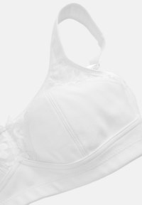 Vitt bh med mjukt bomullsmaterial, spetsdetaljer på sidorna, en slät yta, justerbara axelband och en sömlös design.
