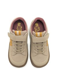 Sneaker in suede beige con una texture liscia, dotate di una striscia in velcro, suola in gomma marrone e fodera interna imbottita rosa. Logo sulla linguetta.