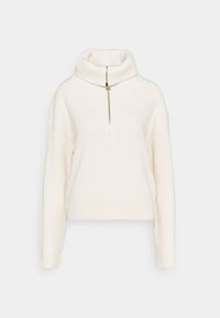 Gestrickter cremefarbener Rollkragenpullover mit Rippenstruktur, ausgestattet mit einem durchgehenden Reißverschluss vorne und locker sitzenden langen Ärmeln.