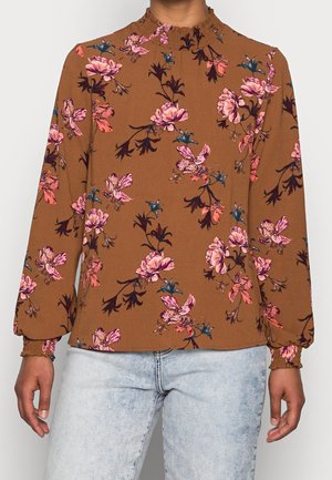 Braunblumenbluse mit langen Ärmeln, einem gerafften Ausschnitt und lockerer Passform, geschmückt mit rosa und blauen Blumenmustern.