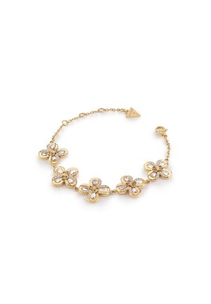 Gouden armband met vijf bloemvormige bedels, elk versierd met heldere kristallen, en een klein driehoekig merkembleem vlak bij het slot.