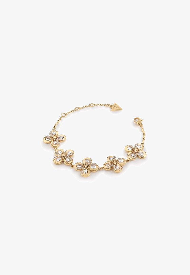 Bracelet en or avec cinq breloques en forme de fleur, chacune ornée de cristaux transparents, et une petite étiquette de marque triangulaire près du fermoir.