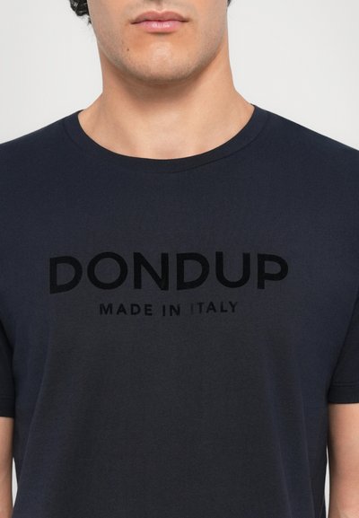 Navy blue cotton t-shirt featuring a crew neck, soft texture, and a prominent black print saying "DON DUP MADE IN ITALY" on the front.