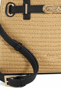 Woven straw handbag with black leather accents and gold hardware. Features a textured surface and adjustable strap. Brand logo embossed.