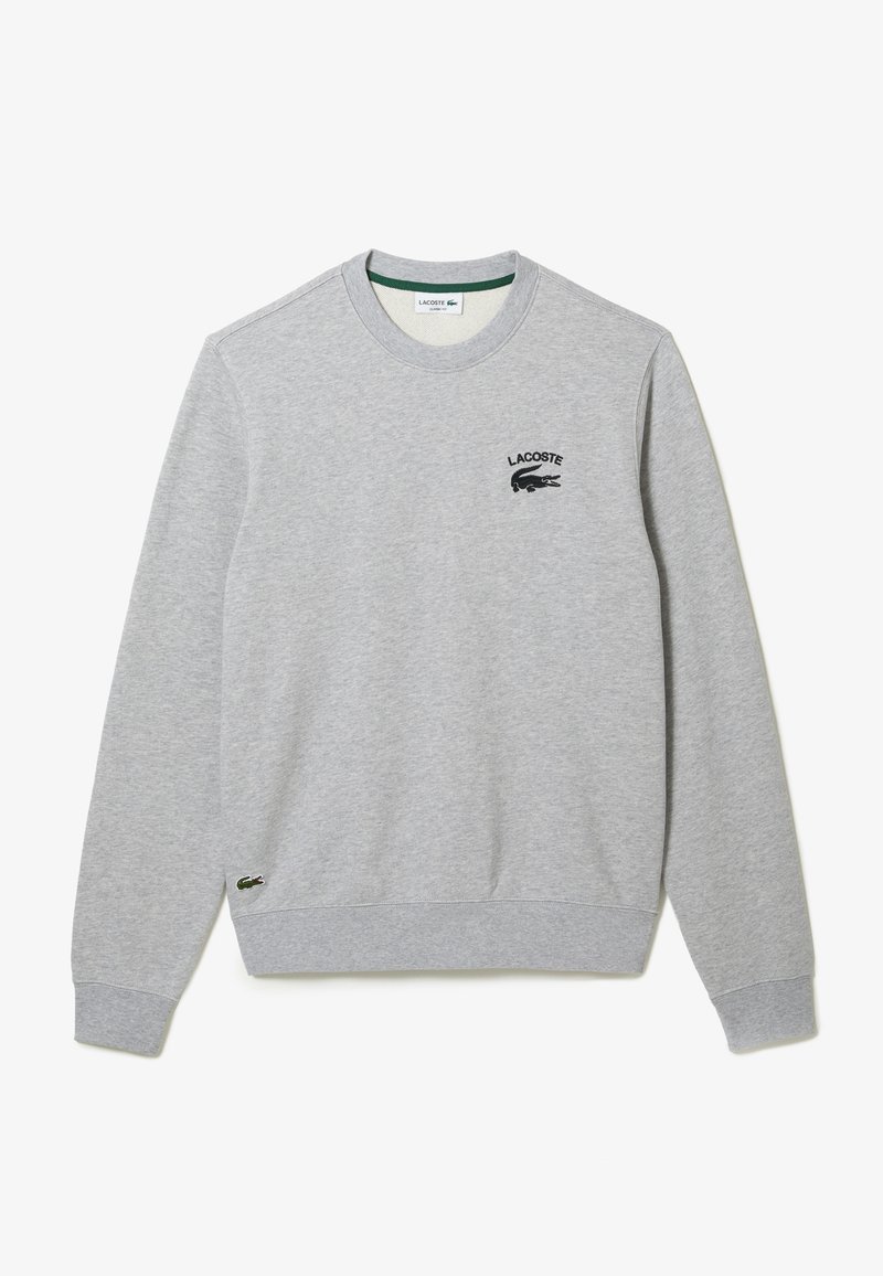 Sweat-shirt gris en mélange de coton avec col rond, poignets et ourlet côtelés. Arbore le logo Lacoste brodé sur la poitrine et un petit emblème de crocodile.