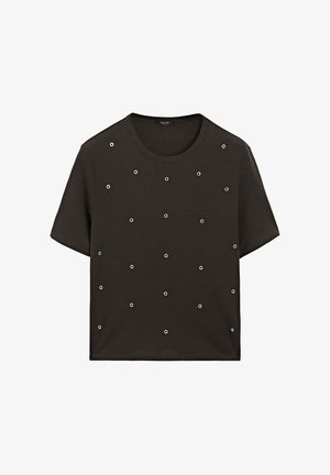 Svart kortärmad t-shirt med flera silveröglor ordnade i ett rutmönster. Tillverkad av mjukt bomullstyg med rund halsringning.