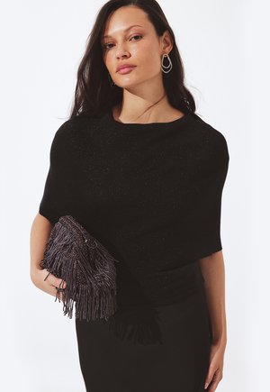 Čierny pletený top s krátkymi rukávmi s jemným trblietaním. Dopĺňa ho textúrovaná kabelka s strapcami v tmavých odtieňoch.