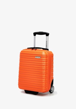 Hard-shell suitcase in bright orange, featuring horizontal ridges, a black retractable handle, and two smooth wheels for mobility.