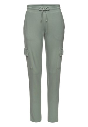 Light green cargo pants with a drawstring waist, side pockets, paired with a white long-sleeve blouse and white sneakers.