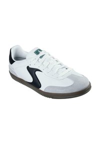 Białe sneakersy z szarym zamszem i czarnymi akcentami; mają teksturowaną gumową podeszwę i sznurowane zapięcie. Zielone logo na języku.