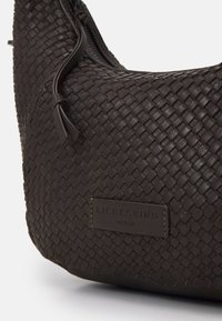 Woven dark brown leather shoulder bag with a zip closure, featuring a textured surface and a branded leather tag.