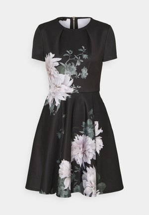 Schwarzes Kleid mit kurzen Ärmeln, rundem Ausschnitt, Reißverschluss auf der Rückseite und großen weißen und grünen Blumenmustern auf Vorderseite und Rock.