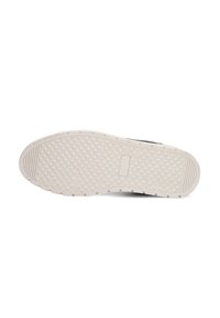 Witte rubberen schoenenzool met een gestructureerde grip, voorzien van een geometrisch patroon en een platte hak, ontworpen voor stabiliteit en grip.