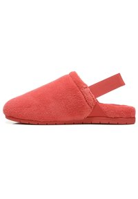 Coral slipper in soft, plush fabric with a back strap for secure fit. Features a flat rubber sole and a rounded toe design.
