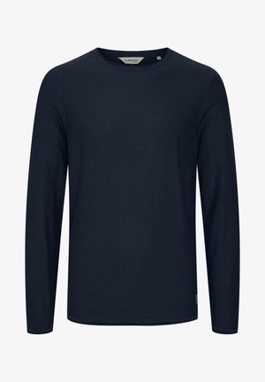 Tumed pikkade varrukatega T-särk, mis on valmistatud pehmest kangast, ümmarguse kaelusega ja sirge helmega. Minimalistlik disain, ilma mustrite või aktsentideta.