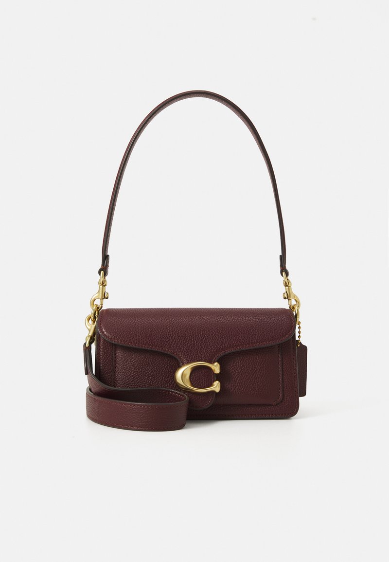 Dark burgundy leather handbag with gold clasp and detachable shoulder strap on plain white background.