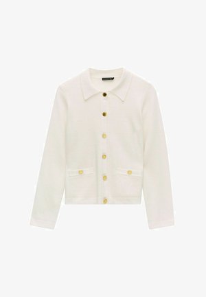 Witte cardigan van gestructureerde stof, met een kraaghalslijn, gouden knopen en twee voorzakken. Lange mouwen.