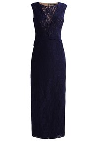 Robe en dentelle marine avec une silhouette ajustée, sans manches, et un motif floral. Elle possède un décolleté en V et une fermeture éclair au dos.