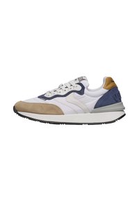 Sneakers blanches et bleu marine avec un embout en suède beige, un corps en tissu texturé et une semelle en caoutchouc grise. Comprend un système de laçage et un col rembourré.
