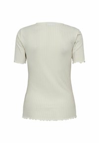 Ribbed short-sleeve top in off-white. Features a fitted shape, scalloped hem, and soft texture. Minimalist design with subtle vertical stripes.