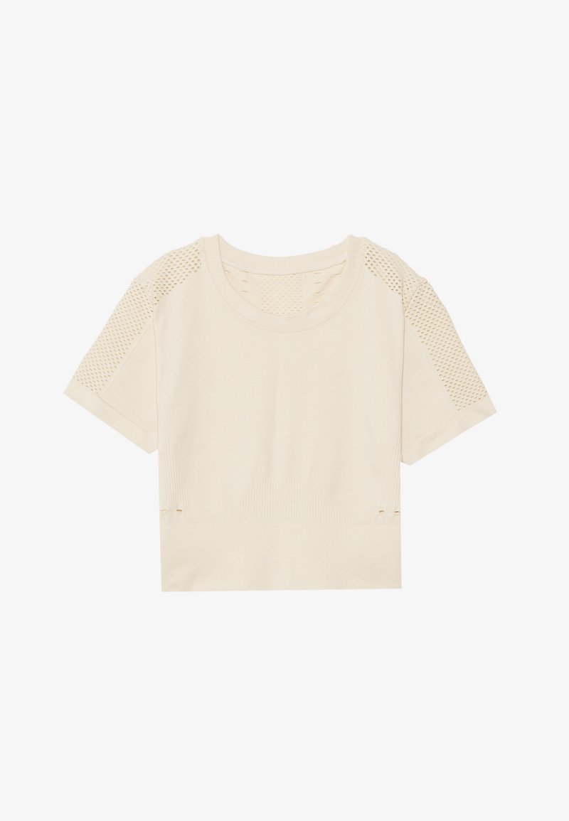 Light beige cropped t-shirt with short sleeves, featuring mesh paneling on shoulders, ribbed texture, and side openings with small gold accents.