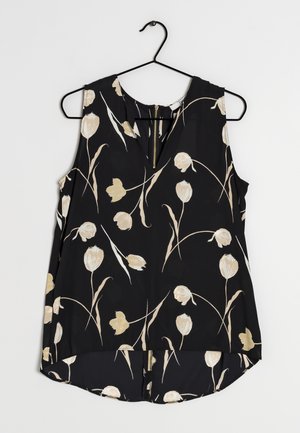 Zwarte mouwloze blouse met beige en witte tulpprint, ronde hals, keyhole en ritssluiting detail, hangend aan een zwarte hanger.