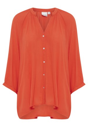 Orange, lätt blus med knappar och halvärmar samt rundad fåll. Texturerad tyg med plisserade detaljer vid halslinningen och ryggen.