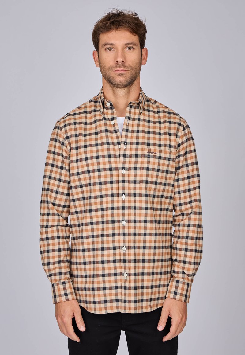 Chemise à carreaux marron et beige avec un col classique, des manches longues et des boutons blancs ; comporte une petite poche poitrine.
