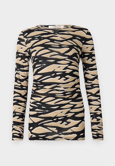 Long-sleeve top featuring a black and beige abstract wave pattern on a smooth, stretchy fabric. Fitted design with round neckline and slim sleeves.