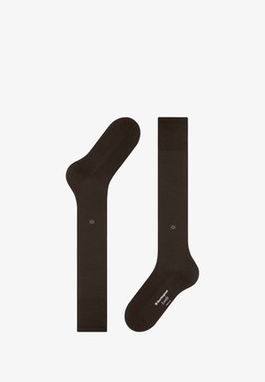 Braune Socken aus weichem Material, mit glatter Textur, standardmäßiger Form und einem kleinen goldenen Logo-Detail an der Seite.