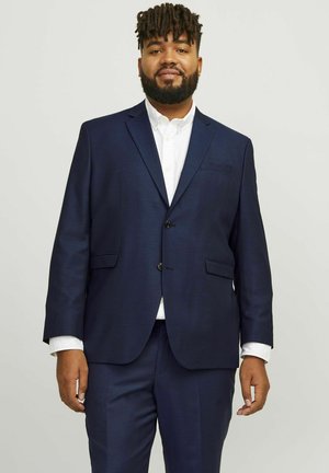 Navy blue suit featuring a single-breasted jacket with two buttons, side pockets, and matching trousers, made from smooth fabric.