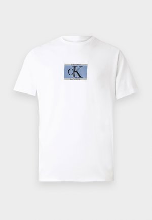 White cotton T-shirt featuring a rectangular graphic with blue and black text reading "Calvin Klein CK New York City" on the front.