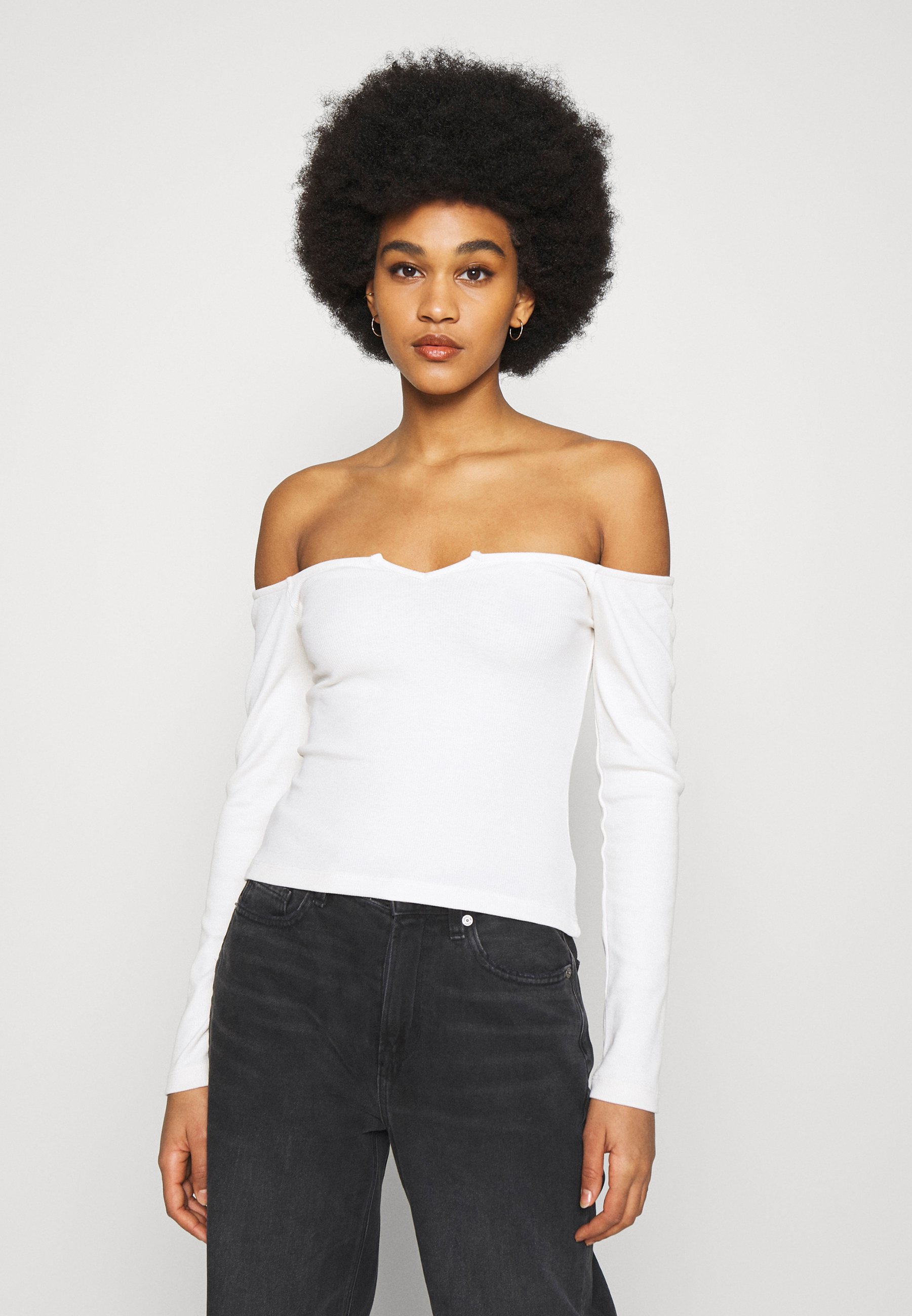 white long sleeve off the shoulder shirt