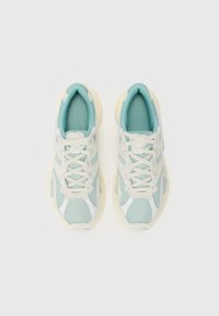 Light blue mesh sneakers with cream accents, padded collar, and lace-up design. Lightweight sole with textured surface and branding details.