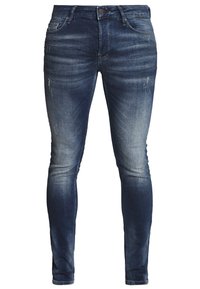 Vaqueros skinny de mezclilla azul oscuro con un lavado descolorido, ligero desgaste y diseño clásico de cinco bolsillos. Cuenta con cierre de cremallera y pasadores para cinturón.