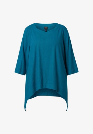 Tunika di lino color turchese con maniche a tre quarti, scollatura a V e orlo asimmetrico più lungo ai lati rispetto a fronte e retro.