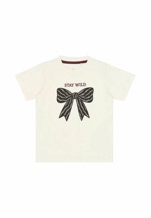 T-shirt blanc à manches courtes avec un grand nœud marron à rayures zèbre et le texte "STAY WILD" au-dessus du nœud sur le devant.