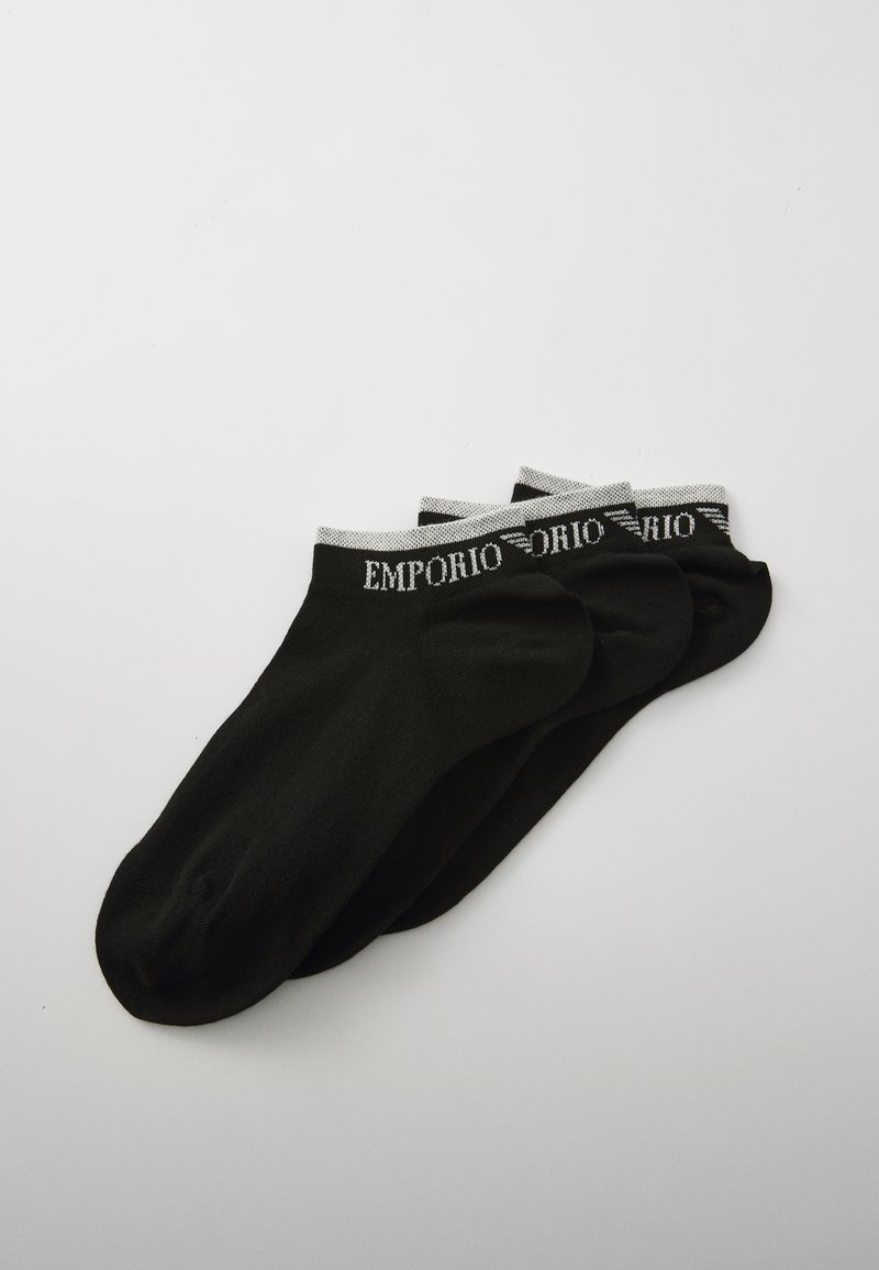 Black ankle socks in a pack of three featuring a white band at the top with "EMPORIO" printed in black. Smooth knit fabric.