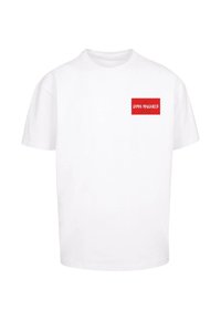 White cotton t-shirt featuring a red rectangular graphic on the left chest with text "DIMA MAGHREB" and a star design. Short sleeves, crew neck.
